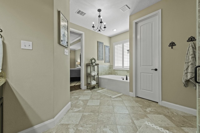 full bathroom featuring baseboards, visible vents, an inviting chandelier, and a garden tub
