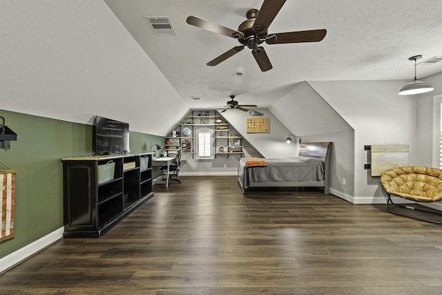 bedroom featuring baseboards, lofted ceiling, wood finished floors, and visible vents