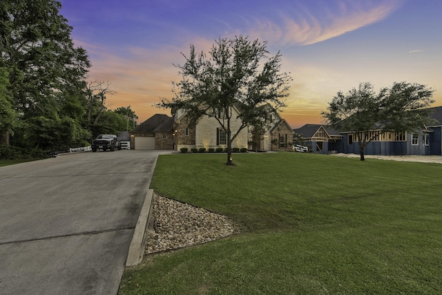 view of front of home with concrete driveway and a front yard