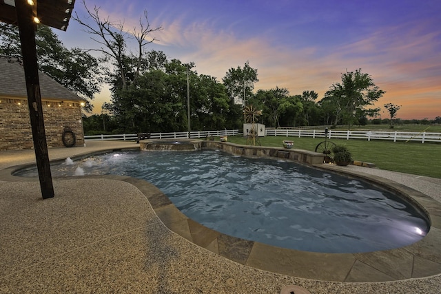 view of pool with a lawn, a pool with connected hot tub, and a fenced backyard