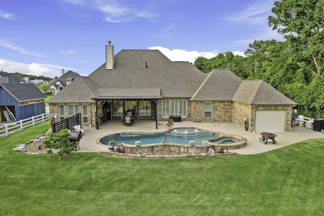 view of pool featuring fence, a patio, a lawn, and a pool with connected hot tub