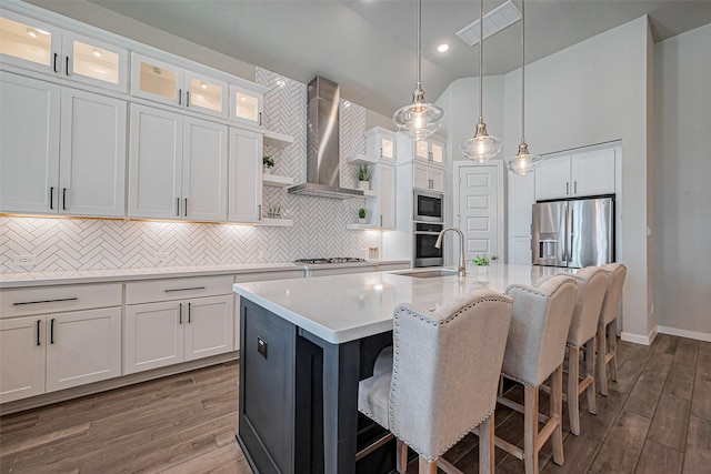 2502 Forest Side Ct, Missouri City, TX 77459 - kitchen with a sink, wall chimney range hood, light countertops, dark wood-style floors, and appliances with stainless steel finishes