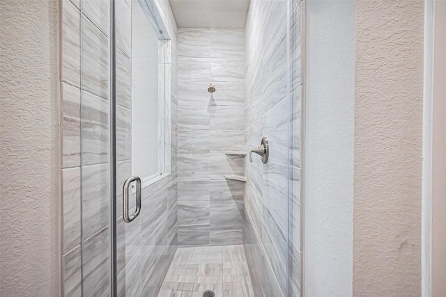 2502 Forest Side Ct, Missouri City, TX 77459 - bathroom with a shower stall and a textured wall