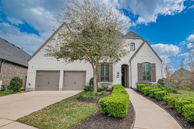 2502 Forest Side Ct, Missouri City, TX 77459 - french provincial home featuring concrete driveway, brick siding, and an attached garage