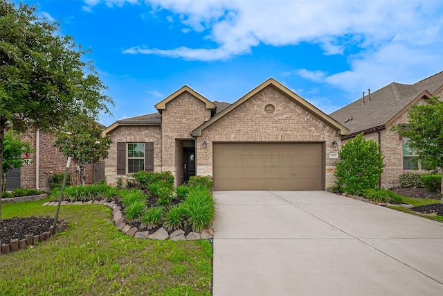 2903 Blue Mist Bnd, Brookshire, TX 77423 - view of front of house featuring an attached garage, concrete driveway, brick siding, a front lawn, and roof with shingles