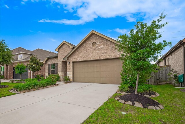 2903 Blue Mist Bnd, Brookshire, TX 77423 - view of front of home featuring brick siding, a garage, and driveway