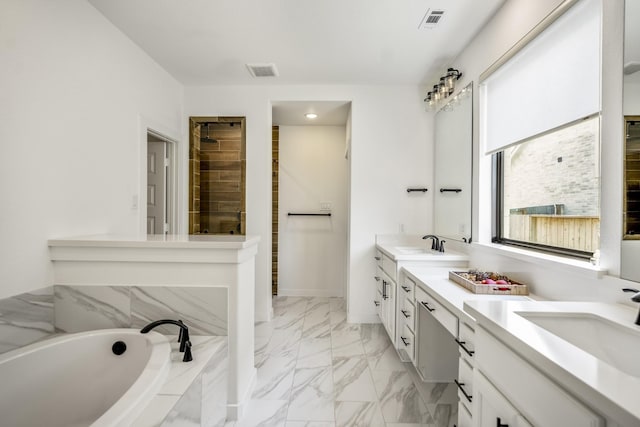 bathroom featuring a sink, a garden tub, double vanity, and visible vents