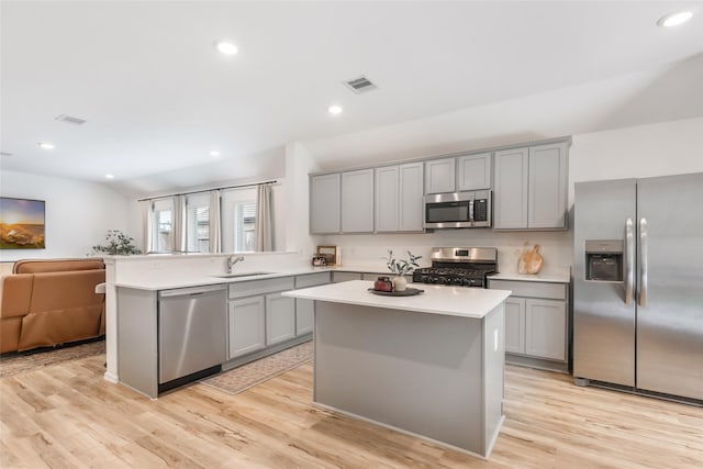 21623 Mount Frisell Ln, Porter, TX 77365 - kitchen featuring visible vents, open floor plan, gray cabinets, a sink, and appliances with stainless steel finishes