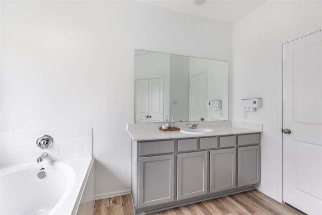 21623 Mount Frisell Ln, Porter, TX 77365 - bathroom with baseboards, wood finished floors, a bath, and vanity