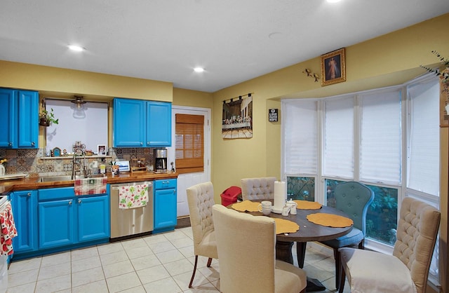 kitchen featuring backsplash, blue cabinetry, and dishwasher