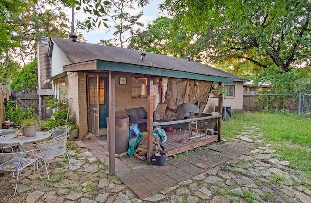 view of outdoor structure featuring central air condition unit and a fenced backyard