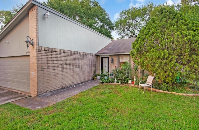 view of front of house with brick siding, a garage, a front lawn, and a shingled roof