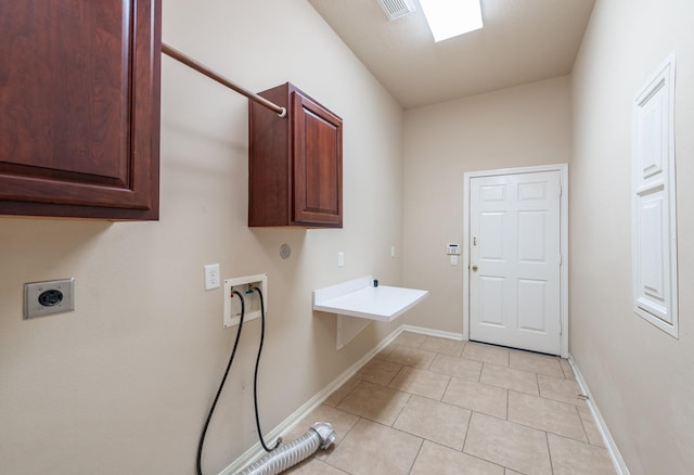 laundry room with cabinet space, washer hookup, electric dryer hookup, light tile patterned floors, and visible vents