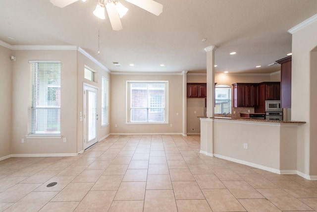 kitchen featuring stainless steel appliances, light tile patterned floors, and a wealth of natural light