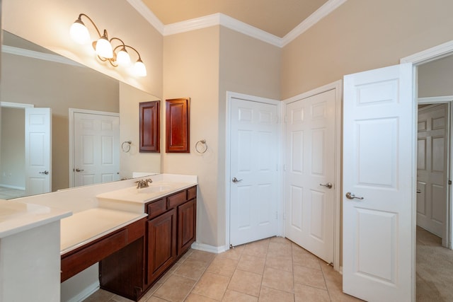 bathroom with vanity, ornamental molding, baseboards, and tile patterned flooring