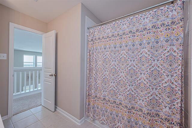 bathroom featuring tile patterned floors, curtained shower, and baseboards