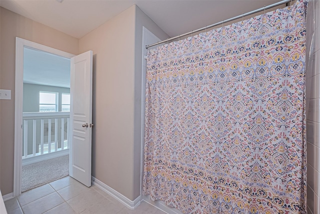 11351 Needlerock Ct, Humble, TX 77396 - bathroom with tile patterned floors, baseboards, and curtained shower