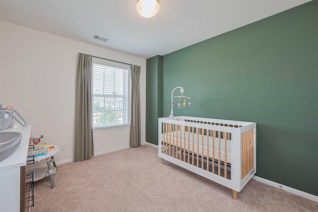 11351 Needlerock Ct, Humble, TX 77396 - bedroom featuring carpet, a crib, and baseboards