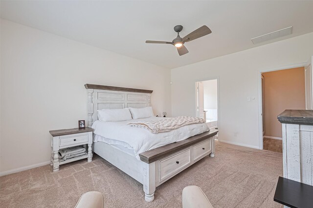 bedroom featuring baseboards, ceiling fan, visible vents, and light carpet