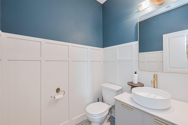 bathroom featuring vanity and toilet