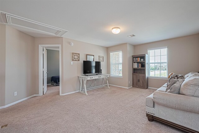 living room with baseboards, attic access, carpet floors, and visible vents