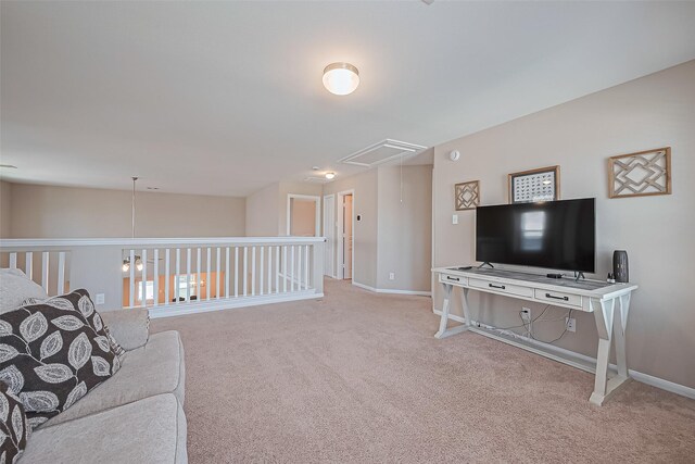 living room with baseboards, attic access, and carpet