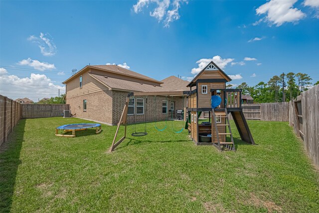 view of jungle gym with a fenced backyard, a trampoline, and a yard