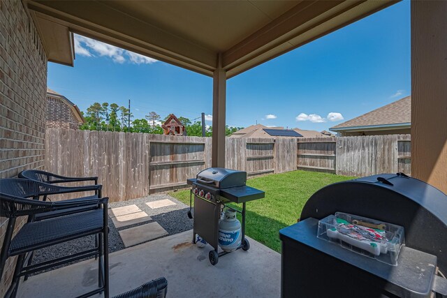 view of patio / terrace with a fenced backyard and a grill