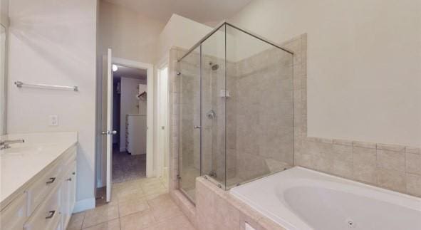 full bathroom featuring a garden tub, vanity, tile patterned flooring, and a stall shower