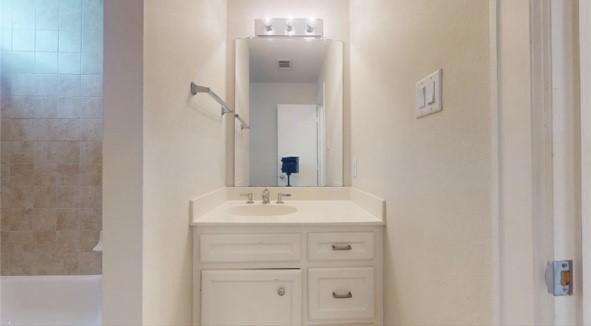 bathroom with vanity and  shower combination