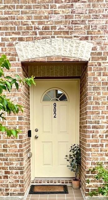 entrance to property with brick siding