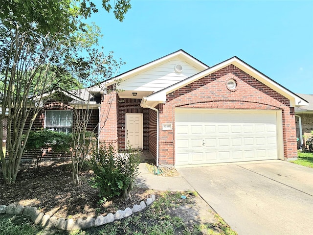 view of front of property with brick siding, an attached garage, and driveway