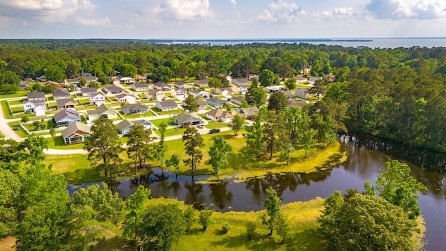 aerial view with a water view, a view of trees, and a residential view