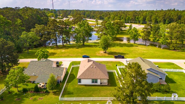drone / aerial view featuring a water view and a forest view