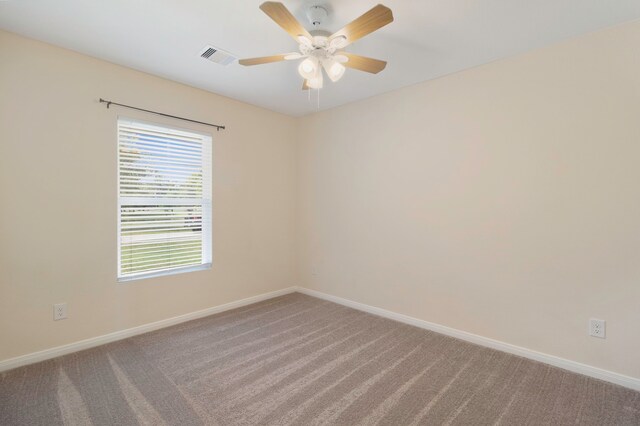 spare room with carpet flooring, baseboards, visible vents, and ceiling fan