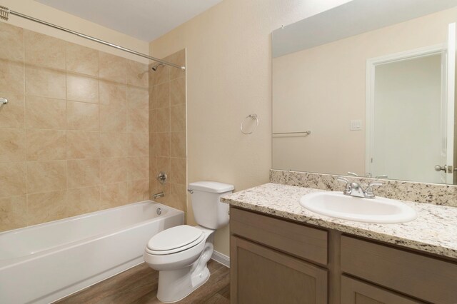 full bathroom featuring vanity, shower / bath combination, wood finished floors, and toilet