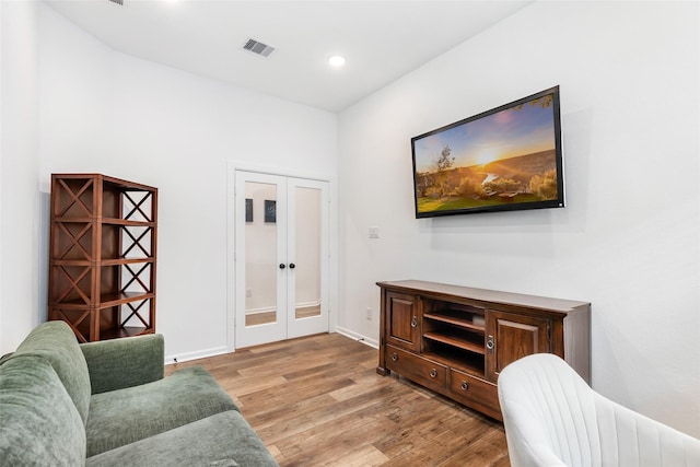 sitting room featuring visible vents, wood finished floors, baseboards, recessed lighting, and french doors
