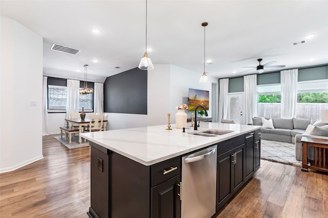 kitchen featuring a sink, stainless steel dishwasher, open floor plan, and visible vents