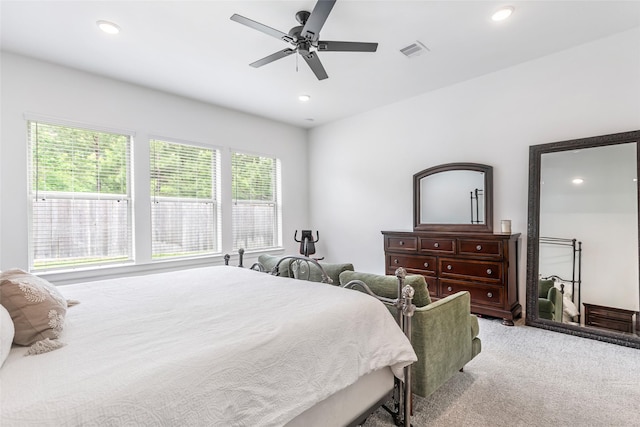 bedroom with visible vents, recessed lighting, and light carpet
