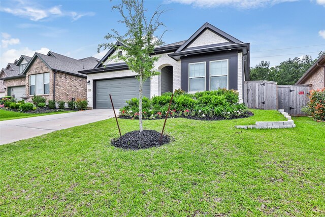 ranch-style house featuring fence, an attached garage, a front lawn, brick siding, and driveway