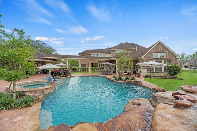 pool with a lawn, an in ground hot tub, and a patio area