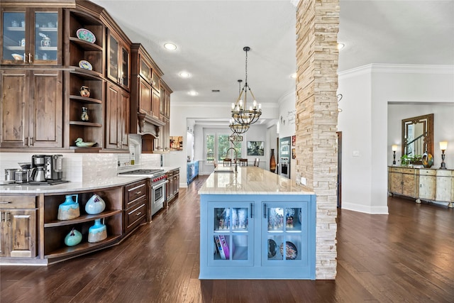 kitchen with crown molding, decorative columns, open shelves, and a notable chandelier