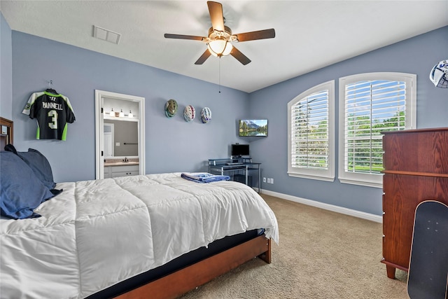 bedroom featuring carpet flooring, a ceiling fan, baseboards, ensuite bathroom, and visible vents
