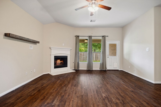 unfurnished living room with ceiling fan, visible vents, baseboards, wood finished floors, and a lit fireplace