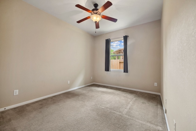spare room with baseboards and carpet