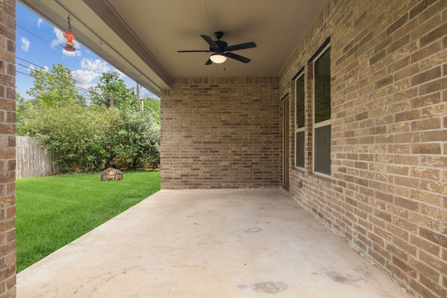 view of patio featuring ceiling fan and fence