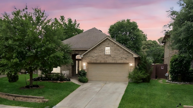 122 Jacobs Meadow Dr, Conroe, TX 77384 - view of front of house featuring brick siding, concrete driveway, a yard, a shingled roof, and a garage