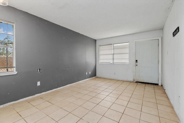 6201 Batterson St, Houston, TX 77026 - unfurnished room featuring a healthy amount of sunlight and light tile patterned floors