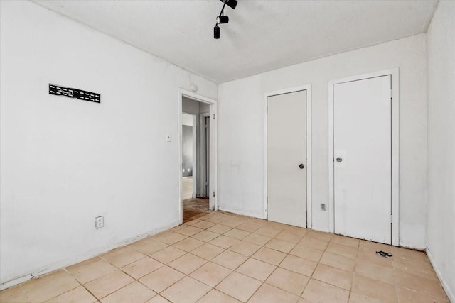 6201 Batterson St, Houston, TX 77026 - unfurnished bedroom featuring a ceiling fan and light tile patterned floors