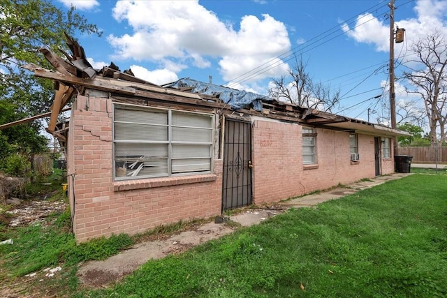 6201 Batterson St, Houston, TX 77026 - view of side of home featuring brick siding, fence, and a yard